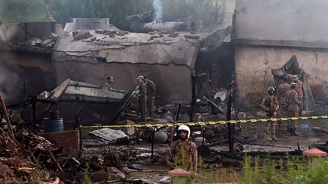 পাকিস্তানের সামরিক প্রশিক্ষণ উড়োজাহাজ আবাসিক এলাকায় বিধ্বস্ত হলে ১৮ জনের মৃত্যু হয়। ছবি: এএফপি
