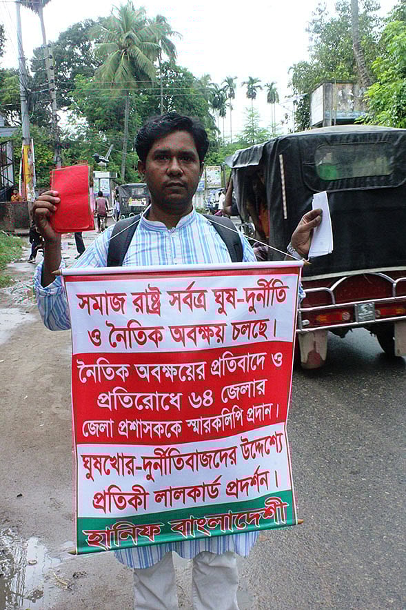 ঘুষ-দুর্নীতি ও নৈতিক অবক্ষয়ের বিরুদ্ধে প্রতিবাদ জানিয়ে সারা দেশে ঘুরছেন নোয়াখালীর যুবক মো. হানিফ। জেলা প্রশাসকের কার্যালয়, চুয়াডাঙ্গা, ২৪ সেপ্টেম্বর। ছবি: শাহ আলম