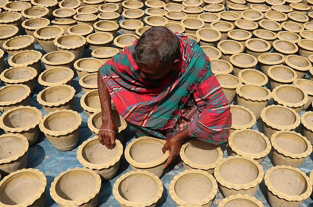 বাড়ির উঠানে কাজ করছেন কুমার