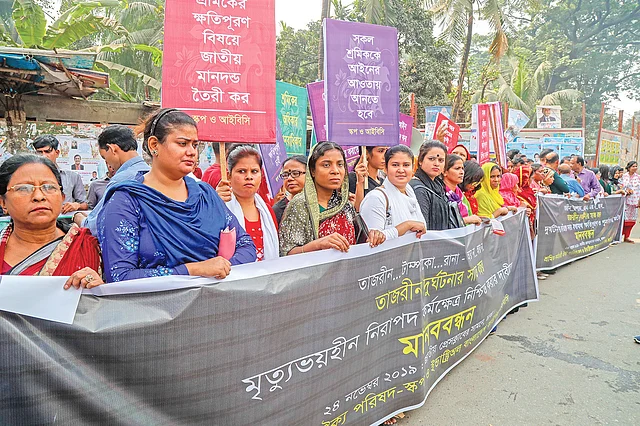তাজরীন ফ্যাশনসের অগ্নিকাণ্ডের ঘটনায় দোষীদের শাস্তি, ক্ষতিপূরণের জাতীয় মানদণ্ড নির্ধারণসহ বিভিন্ন দাবিতে শ্রমিক কর্মচারী ঐক্য পরিষদ (স্কপ) ও ইন্ডাস্ট্রিঅল বাংলাদেশ কাউন্সিলের (আইবিসি) নেতা–কর্মীরা মানববন্ধন করেন। গতকাল রাজধানীর জাতীয় প্রেসক্লাবের সামনের সড়কে। ছবি: প্রথম আলো