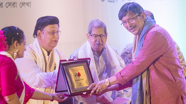 কাইজার চৌধুরীর হাতে ‘চন্দ্রাবতী একাডেমি শিশুসাহিত্য পুরস্কার ২০১৯’-এর স্মারক তুলে দেন পররাষ্ট্রমন্ত্রী এ কে আব্দুল মোমেন। ছবি: প্রথম আলো