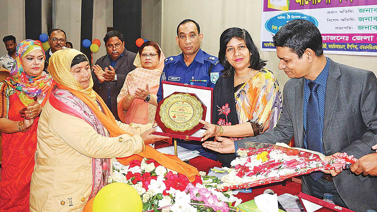 অর্থনৈতিকভাবে সাফল্য অর্জনকারী হিসেবে জয়িতা সম্মাননা নিচ্ছেন জমিলা বেগম। গত সোমবার দিনাজপুর জেলা শিল্পকলা একাডেমির মিলনায়তনে। ছবি: প্রথম আলো