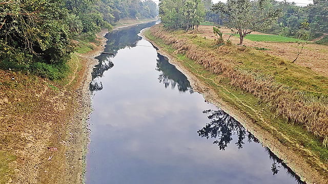জয়পুরহাটের আক্কেলপুর উপজেলার পাশ দিয়ে বয়ে যাওয়া তুলসীগঙ্গা নদীর পানি কালচে রং ধারণ করেছে। সম্প্রতি নবাবগঞ্জ সেতুর ওপর থেকে তোলা।  প্রথম আলো