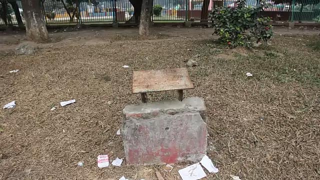 এই স্মারক স্তম্ভটিতে কী লেখা হয়েছিল তা এখন আর উদ্ধার করা সম্ভব না। শিশু পার্কের দেয়াল ঘেসে এভাবে অনাদরে, অবহেলায় পড়ে আছে। ছবি: মনিরুল আলম