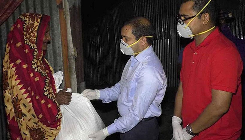ভিক্ষুক সাবিয়ার হাতে গতকাল শুক্রবার রাতে খাদ্যসামগ্রী তুলে দেন নওগাঁর জেলা প্রশাসক হারুন-অর-রশীদ। ছবি: সংগৃহীত