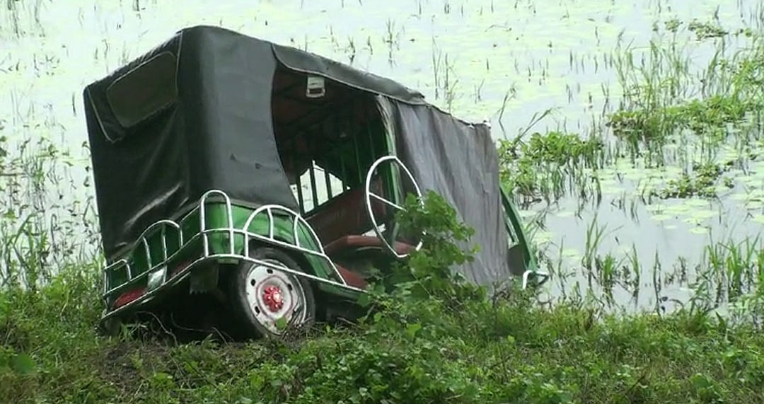 যাত্রীবাহী বাসের ধাক্কায় মহাসড়কের পাশের খাদে পড়ে যাওয়া ইজিবাইক। আজ রোববার সকাল সাড়ে নয়টায় ঢাকা-খুলনা মহাসড়কের গোপালগঞ্জ সদর উপজেলার হরিদাসপুর নিমতলা এলাকায়। ছবি: প্রথম আলো