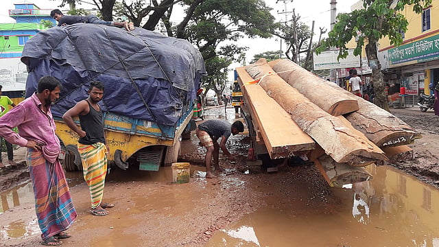 দাউদকান্দির আঙ্গাউড়া নামক স্থানে পণ্যবাহী ট্রাক ও ট্রাক্টর আটকে যাওয়ায় যানবাহন চলাচল বন্ধ হয়ে গেছে। সকাল ১০টায় তোলা ছবি। প্রথম আলো