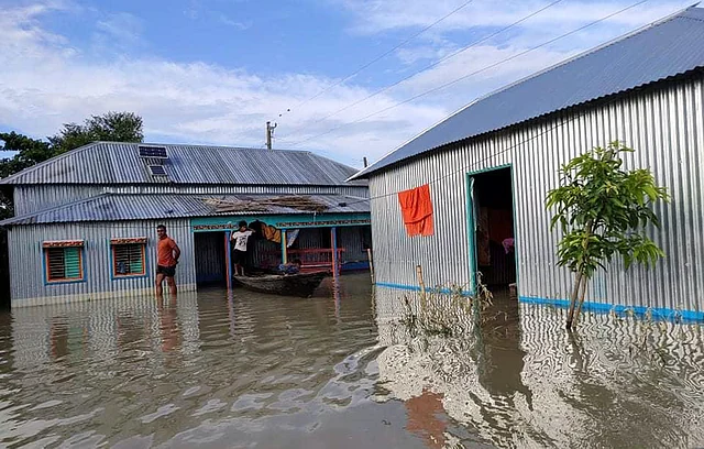 বাড়িতে উঠেছে পানি। তলিয়ে গেছে বসতঘর। দৌলতপুরের চরকাটারী গ্রামে। ছবি: প্রথম আলো