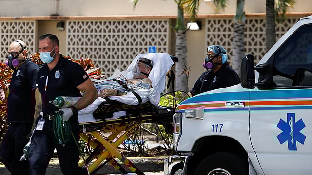 করোনায় সংক্রমিত একজন রোগীকে ফ্লোরিডার হিয়ালেহ হাসপাতালে নিয়ে যাচ্ছেন জরুরি বিভাগের কর্মীরা। ছবি: রয়টার্স