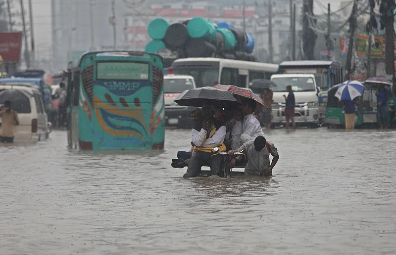 কোমরসমান পানিতে ভ্যানে করে গন্তব্যে যাচ্ছেন কয়েকজন