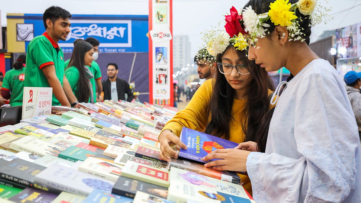 স্টলে পছন্দের বই দেখছে দুই পাঠক