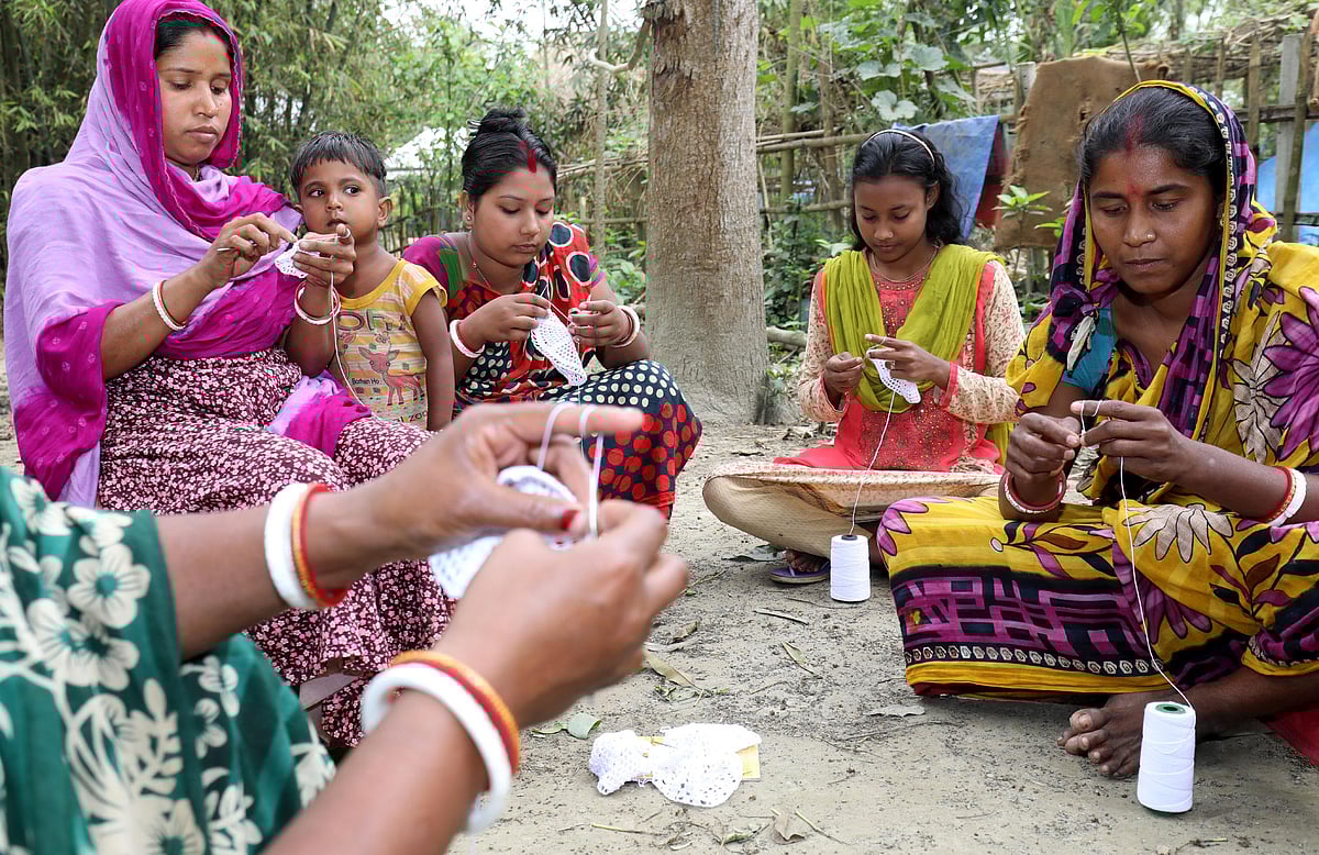 বাড়ির উঠানে বসে টুপি বানাচ্ছেন নারীরা।