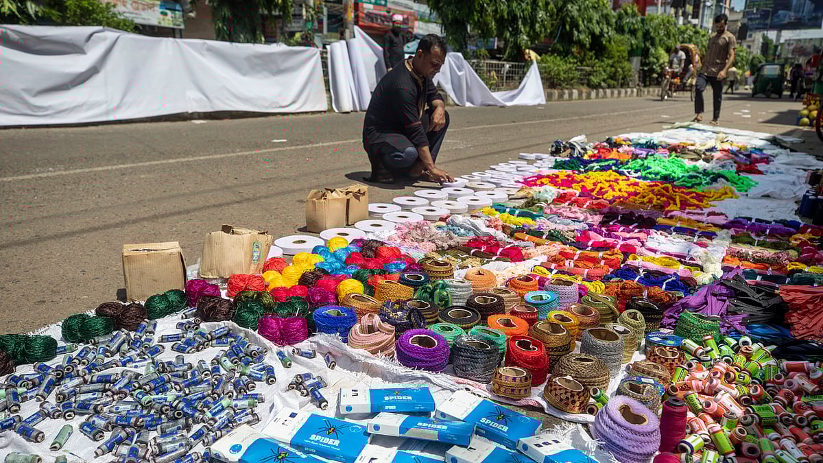 বন্যার পানিতে ভিজে যাওয়া বিভিন্ন পণ্য রোদে শুকাতে দিয়েছেন এক ব্যবসায়ী।