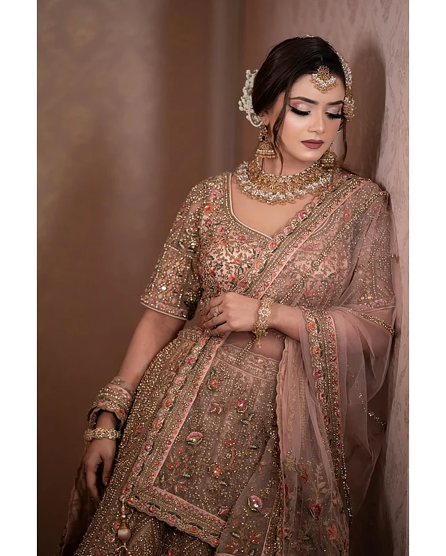 তানজিন তিশার পিচরঙা লেহেঙ্গায় ব্রঞ্জের কারুকাজ করা। ছোট ছোট ফ্লোরাল এমব্রয়ডারিও নজর কাড়ছে। এই পোশাকের সঙ্গে জমকালো আমেজের সোনা ও মুক্তার অলংকার পরেছেন তিনি। সাজেও জমকালো ভাব। 