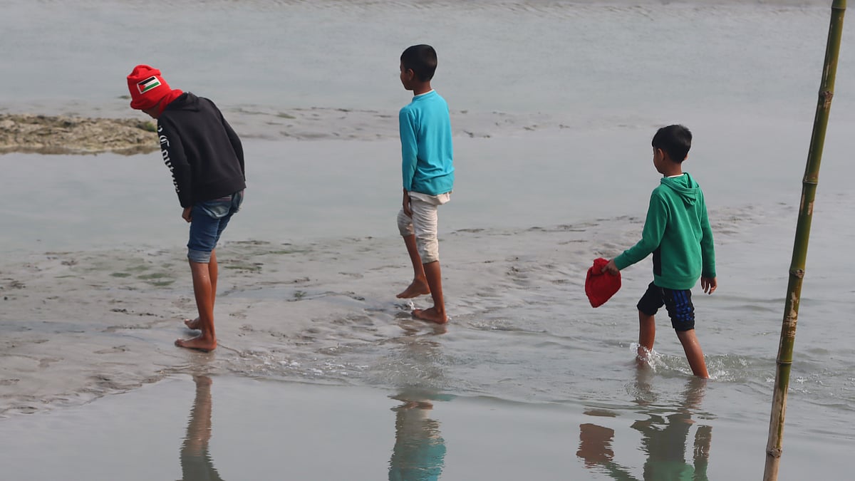 হাঁটুপানি পেরিয়ে চরে খেলতে যাচ্ছে এই শিশু-কিশোরেরা