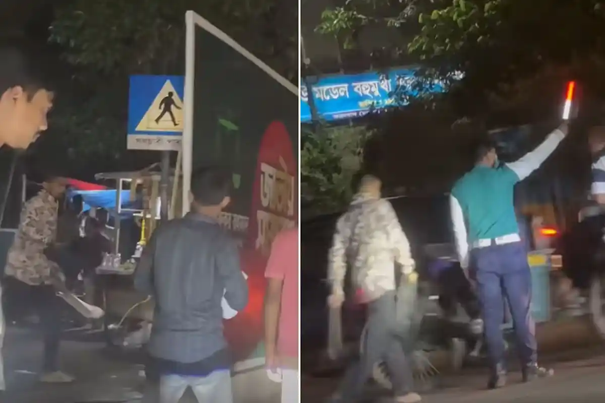 ধানমন্ডি ৩২ নম্বরের রাসেল স্কয়ারের সামনে চাপাতি ধরে ব্যাগ ছিনিয়ে নেওয়ার পর সেই অস্ত্র হাতে পুলিশের সামনে দিয়ে চলে যাচ্ছে ছিনতাইকারী