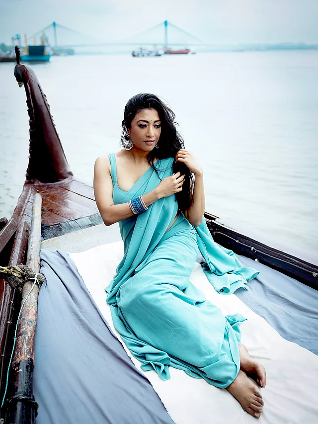 গঙ্গার পাড়ে নৌকার ওপর বসে আছেন পাওলি দাম। ক্ল্যাসিক বাঙালি সৌন্দর্যের এক আধুনিক রূপ ফুটে উঠেছে তাঁর লুকে।