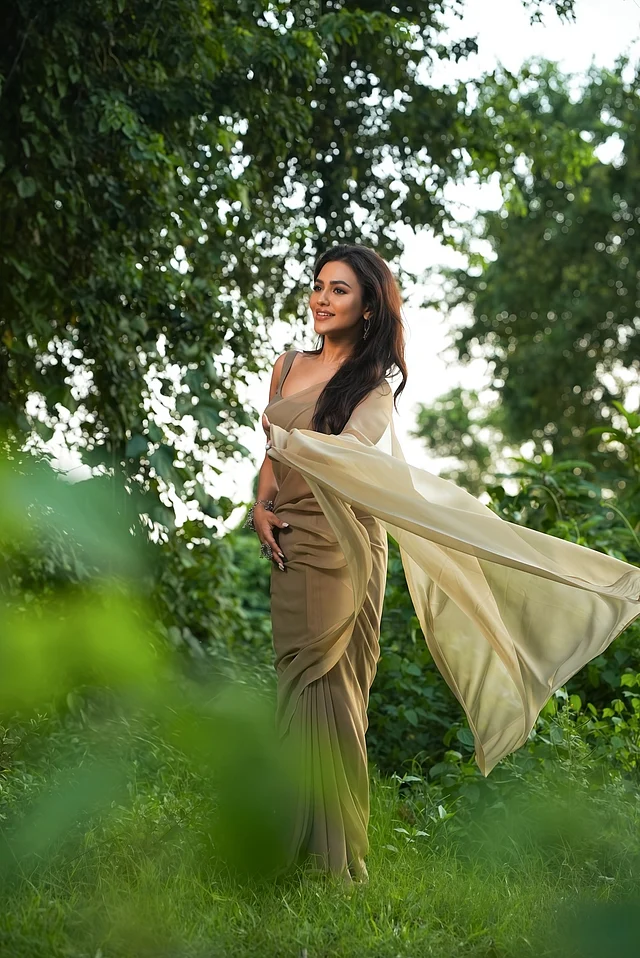 সাফিয়া সাথীর ডিজাইনের, হালকা অলিভ-টোনড জর্জেট শাড়িতে ফারিয়ার উপস্থিতি যেন প্রকৃতির ভেতর এক শিল্পকর্মের মতোই।