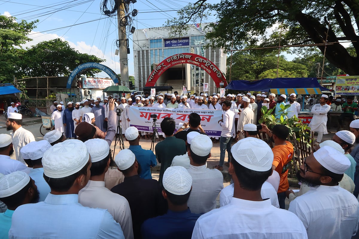 হেযবুত তওহীদের কার্যক্রম বন্ধের দাবিতে হেফাজতে ইসলামের মানববন্ধন। সোমবার বিকেলে রাজশাহী নগরের সিঅ্যান্ডবি মোড় এলাকায়ছবি: প্রথম আলো