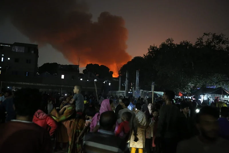  আগুনে পুড়ছে ঘর, দূর থেকে তা দেখছেন বস্তির বাসিন্দারা। 