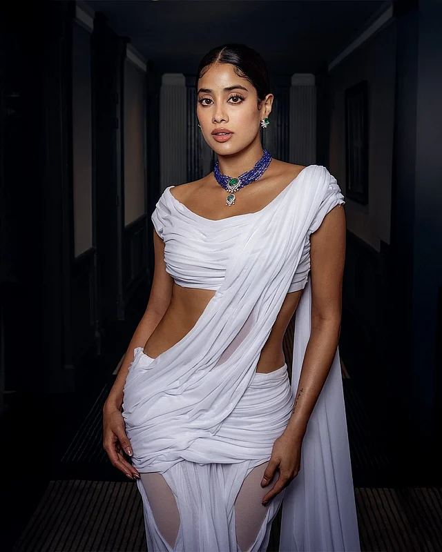 সাদা ‘ড্রিপিং শাড়ি’তে জাহ্নবী যেন ফরাসি রিভিয়েরায় ফিরিয়ে এনেছেন বলিউডের নস্টালজিয়া। ‘ওয়েট লুক’-এর সঙ্গে শাড়ি ও ব্লাউজের আধুনিক ড্রেপ—লুকটিকে করে তুলেছে আকর্ষণীয়