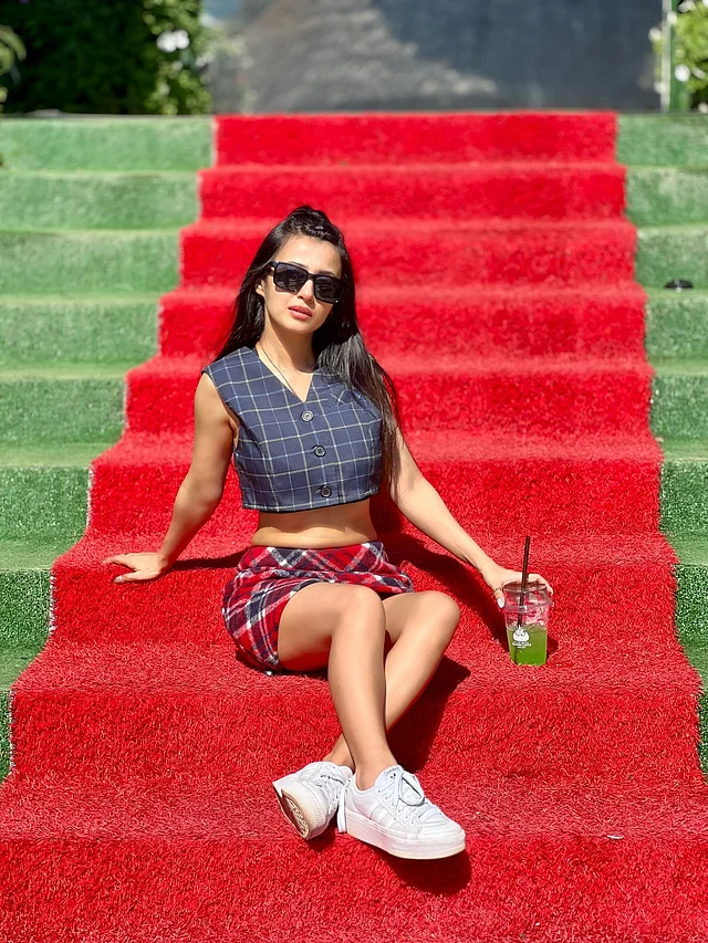 চেকার্ড প্যাটার্নের আউটফিটে মনামী ঘোষের লুকে স্পষ্ট রেট্রো আমেজ। নেভিব্লু স্লিভলেস ক্রপ টপের সঙ্গে লাল, নীল এবং সাদা রঙের ভেলভেট মিনি স্কার্ট পরেছেন তিনি। 