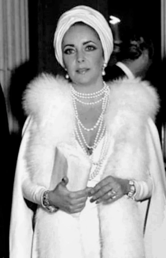 এই সাদা ড্রেসের লুকটি এলিজাবেথের আইকনিক লুকগুলোর একটি। 