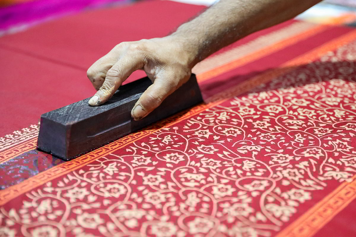 কাঠের ছাঁচে কারিগরের নিপুণ হাতে কাপড়ে ফুটে উঠছে ব্লক প্রিন্টের নকশা
 