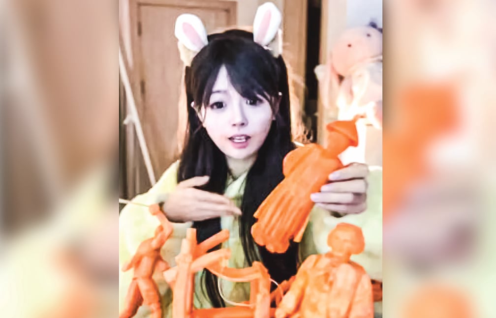 দাঁত দিয়ে গাজরে ভাস্কর্য বানান চীনা তরুণী