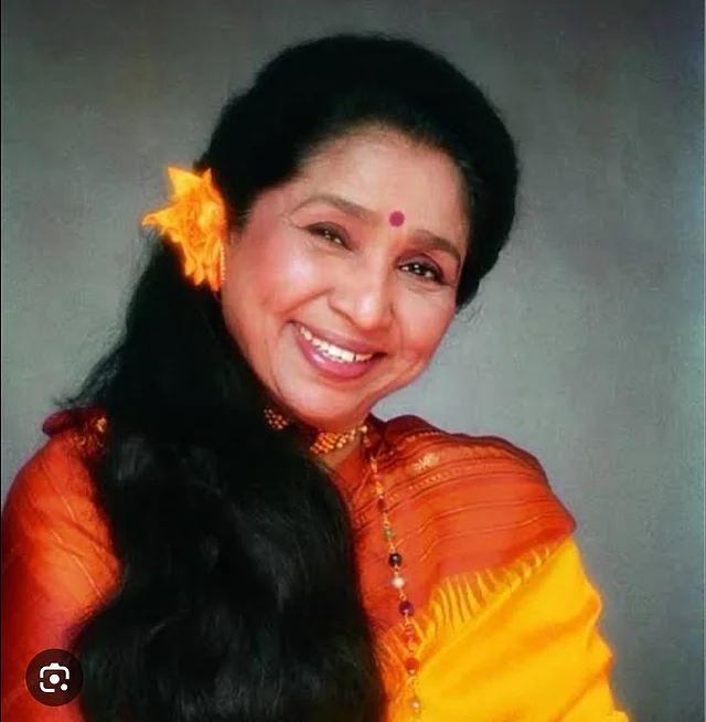 হলুদ ফুল গুঁজেছেন আশা খোলা চুলে। পরেছেন লাল পাড়ের বাসন্তী শাড়ি