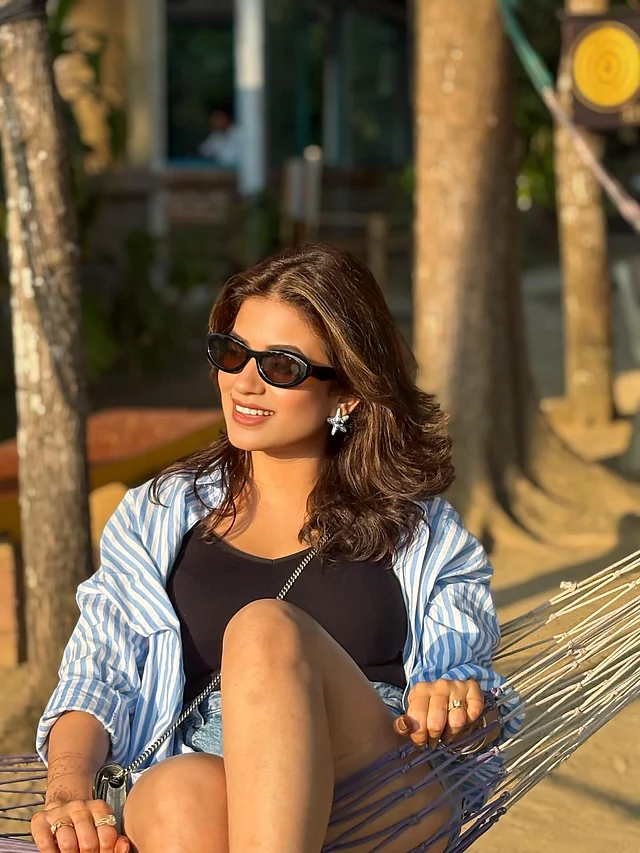 এ সময় কোথাও ঘুরতে গেলে অভিনেত্রী মন্দিরার এই লুক থেকে অনুপ্রেরণা নেওয়া যেতে পারে। কালো ট্যাংক টপের ওপর লেয়ারিং করে তিনি পরেছেন নীল-সাদা স্ট্রাইপের ওভারসাইজড শার্ট। বটমে পরেছেন ডেনিম শর্টস।  