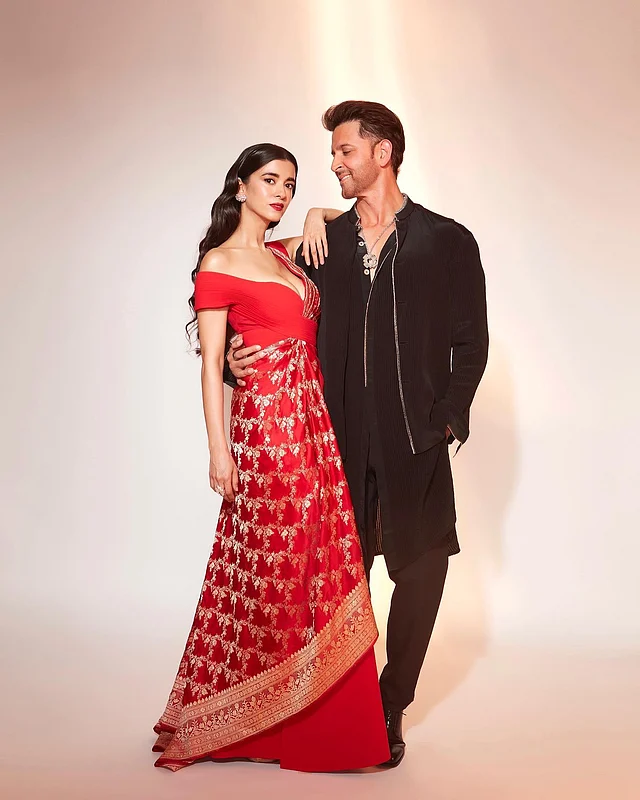 অল ব্ল্যাকে হৃত্বিক। সঙ্গে লাল-সোনালি ডিপ ভি নেক ফিউশন বেনারসি গাউনে সাবা 