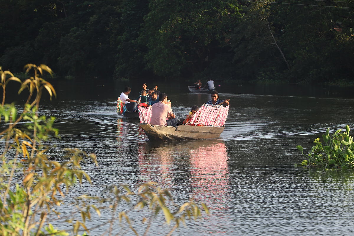 হাওরের জলে নৌকায় ঘুরতে আসেন অনেকেই 