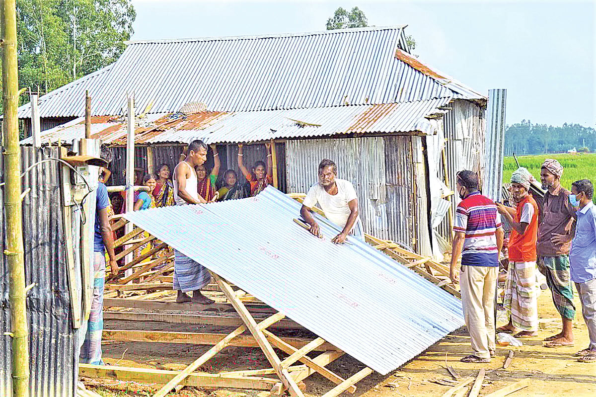 সাম্প্রদায়িক হামলায় পুড়ে যাওয়া মাথা গোঁজার ঠাঁই নতুন করে তৈরিতে ব্যস্ত বাসিন্দারা। গতকাল দুপুরে রংপুরের পীরগঞ্জ উপজেলার মাঝিপাড়া গ্রামের বড়করিমপুর এলাকায়