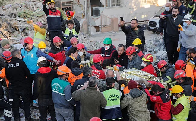 তুরস্কের দক্ষিণাঞ্চলের হাতাই প্রদেশে ধ্বংসস্তূপের নিচে থেকে ১৩ বছরের এক কিশোরকে বের করে আনছেন উদ্ধারকর্মীরা