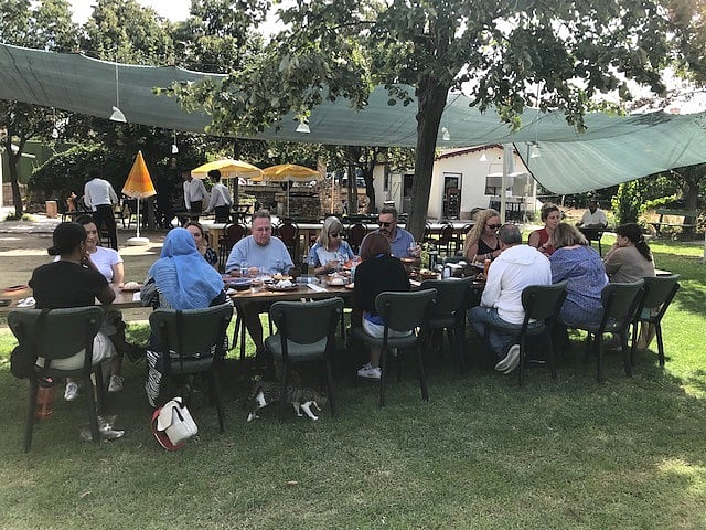 গাছের ছায়ায় খেতে বসেছেন একদল পর্যটক