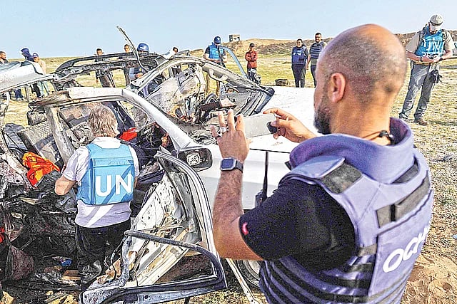 ইসরায়েলি হামলায় যুক্তরাষ্ট্রভিত্তিক সাহায্য সংস্থা ওয়ার্ল্ড সেন্ট্রাল কিচেনের বিধ্বস্ত গাড়িটি পর্যবেক্ষণ করছেন জাতিসংঘের কর্মীরা। ২ এপ্রিল, ফিলিস্তিনের গাজায়