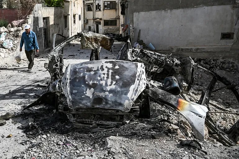 ফিলিস্তিনের পশ্চিম তীরের জেনিন শহরে ইসরায়েলি বাহিনীর অভিযানের পর সড়কের পাশে পড়ে আছে একটি গাড়ির ধ্বংসস্তূপ