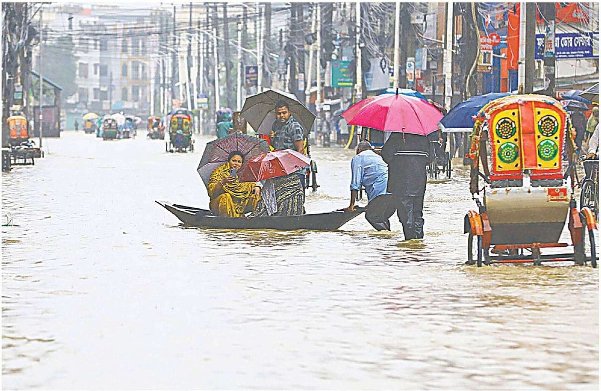 পাহাড়ি ঢল ও ভারী বৃষ্টিতে সিলেট নগরের বিভিন্ন এলাকার মানুষ পানিবন্দী অবস্থায় আছে। রাস্তায় হাঁটু থেকে কোমরসমান পানি। শাহজালাল উপশহরের প্রধান সড়ক, সিলেট, ১৯ জুন সকালে
