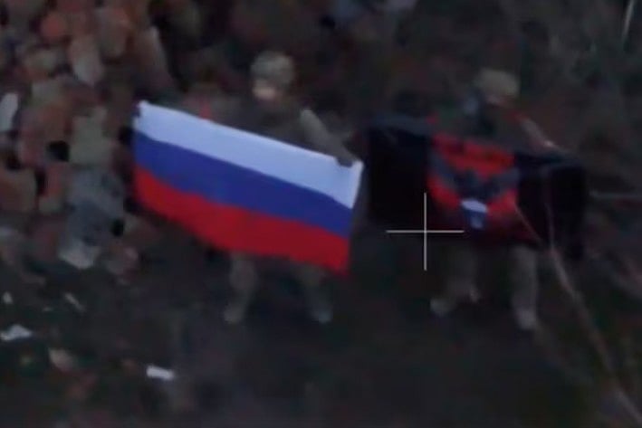 রাশিয়ার এক সেনার হাতে দেশটির জাতীয় পতাকা। ইউক্রেনের দোনেৎস্ক অঞ্চলের কুরাখোভো শহরে, ৫ জানুয়ারি ২০২৫