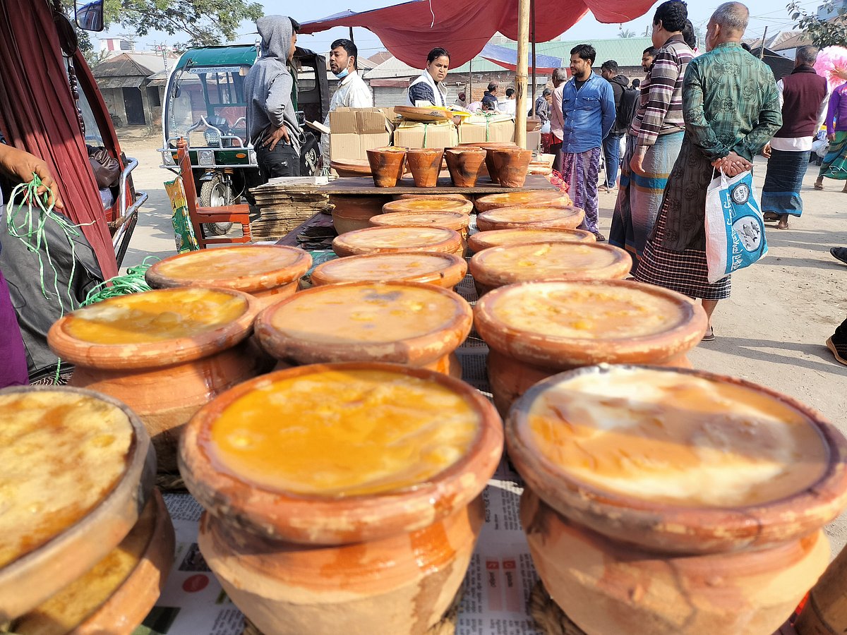 মাটির পাত্রভর্তি দই সাজিয়ে রাখা হয়েছে। আজ সোমবার সিরাজগঞ্জের তাড়াশ উপজেলার রশিক রায় মন্দিরের মাঠে