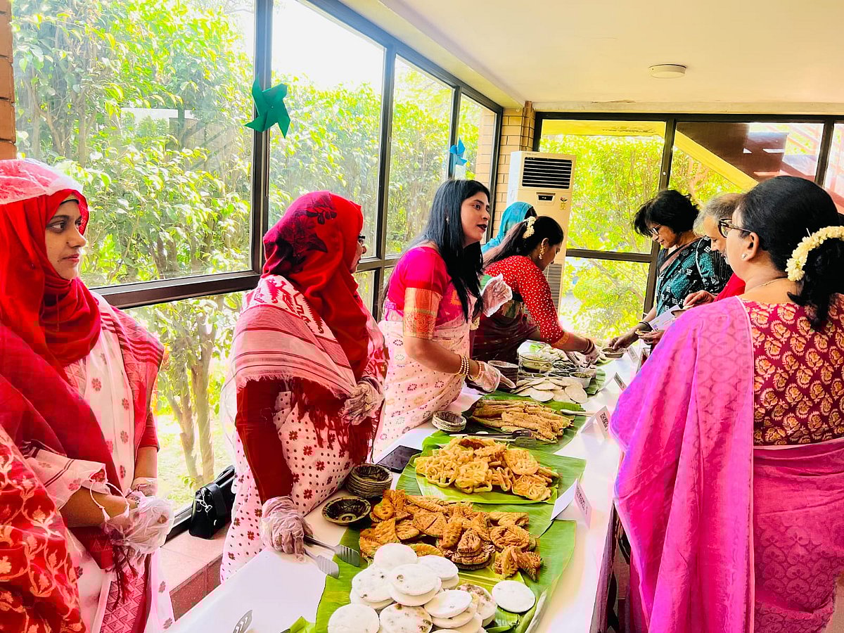 দূতাবাসের কর্মীদের পরিবারের তৈরি পিঠা নিচ্ছেন অতিথিরা। ১৪ এপ্রিল, নয়াদিল্লি