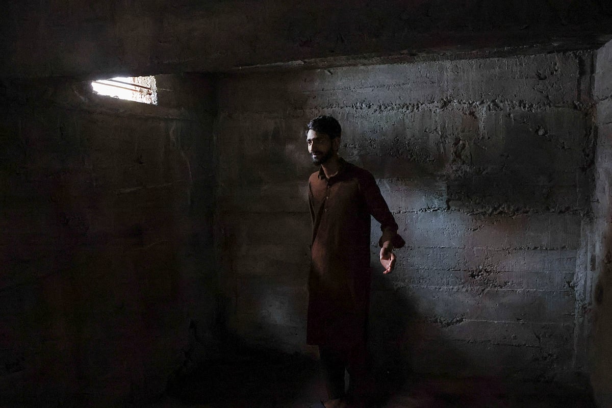 পাকিস্তান–নিয়ন্ত্রিত কাশ্মীরের একটি বাংকারের ভেতর দাঁড়িয়ে আছেন ফায়জান এনায়েত নামের এক বাসিন্দা। ২ মে, চাকোঠি