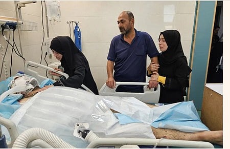 নিবিড় পরিচর্যা কেন্দ্রে স্বামী হামদি আল-নাজ্জারকে দেখছেন চিকিৎসক এলা আল-নাজ্জার (বাঁয়ে)। সম্প্রতি খান ইউনিসের নাসের হাসপাতালে