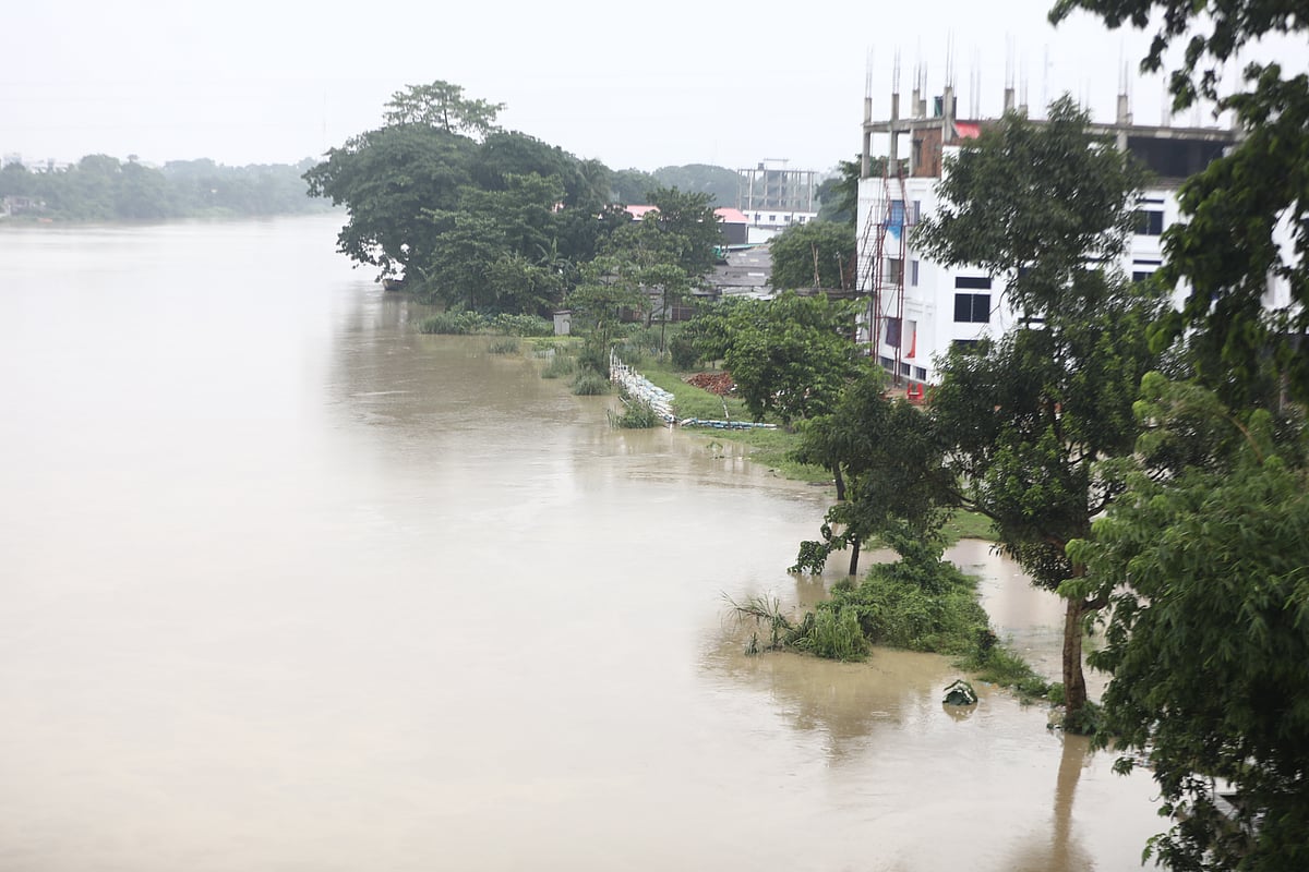 পাহাড়ি ঢলে টইটুম্বর সিলেট নগরের সুরমা নদী। পানি উপচে পড়েছে নদী তীরে। গতকাল বুধবার সকালে নগরের কদমতলী এলাকায়