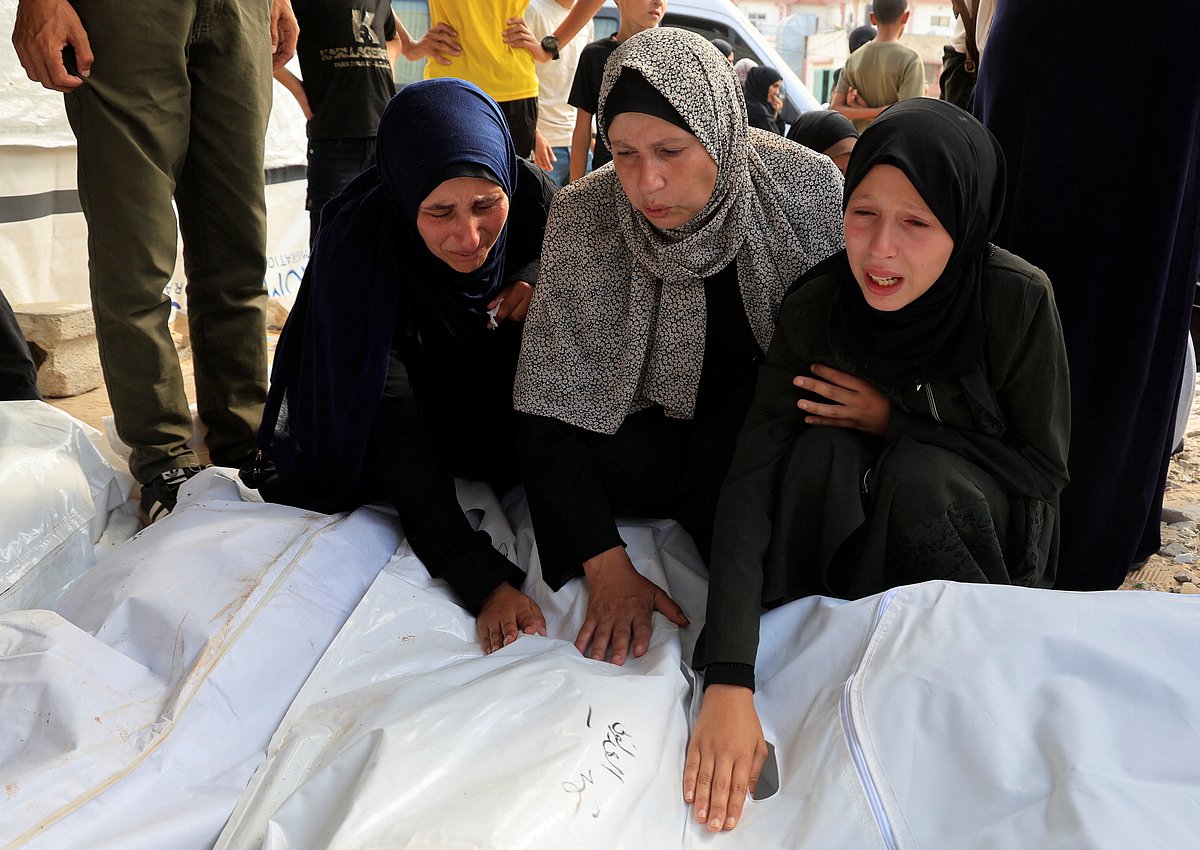 ইসরায়েলের হামলায় নিহত ফিলিস্তিনিদের মরদেহের পাশে স্বজনদের আহাজারি। আজ সোমবার গাজার খান ইউনিসে নাসেরর হাসপাতালে