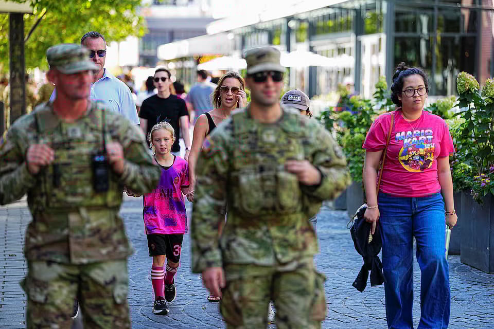 যুক্তরাষ্ট্রের ওয়াশিংটন ডিসিতে একটি সড়কে প্রেসিডেন্ট ডোনাল্ড ট্রাম্পের মোতায়েন করা ন্যাশনাল গার্ডের দুই সদস্যকে দেখা যাচ্ছে। তাঁদের পাশ দিয়ে সাধারণ মানুষ হেঁটে যাচ্ছেন। ২৩ আগস্ট, ২০২৫