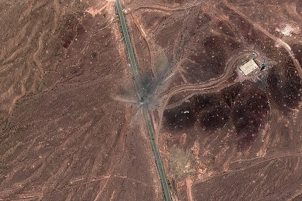 ইরানের ফর্দো জ্বালানি সমৃদ্ধকরণ কেন্দ্রের সুড়ঙ্গের প্রবেশপথ অভিমুখে যাওয়ার সড়কের পাশে বোমার গর্ত। কোম শহরের উত্তর-পূর্বাঞ্চল, ২৪ জুন ২০২৫