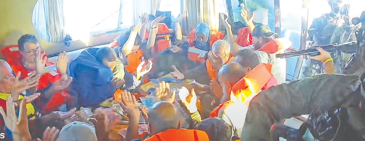 গ্লোবাল সুমুদ ফ্লোটিলার একটি নৌযানে আরোহীরা হাত উঁচিয়ে আছেন। তাঁদের দিকে বন্দুক তাক করেছেন এক ইসরায়েলি সেনা। গতকাল ভূমধ্যসাগরে গাজা অভিমুখে যাত্রাপথে