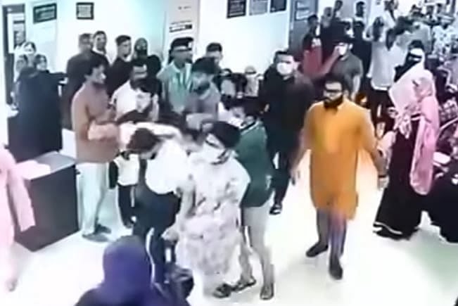 হাসপাতাল থেকে ধরে নিয়ে যাওয়া হচ্ছে এক যুবককে